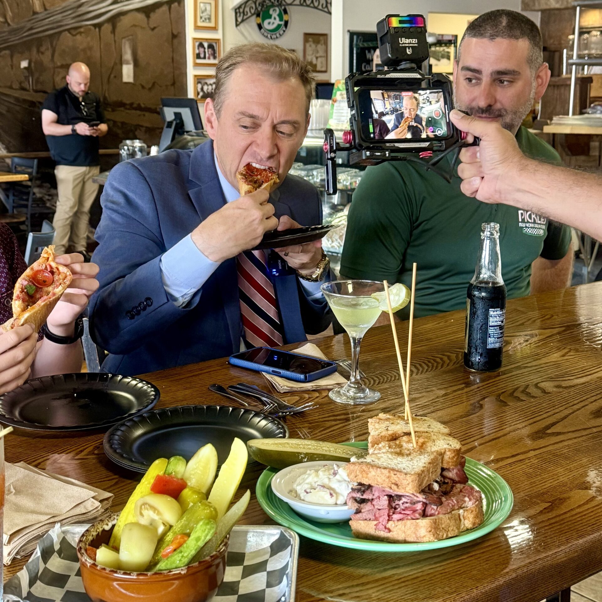 person being filmed eating at a restaurant